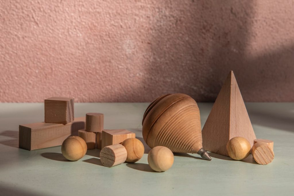 wooden-geometric-shapes-are-arranged-on-a-surface-oxhxkzsn9os